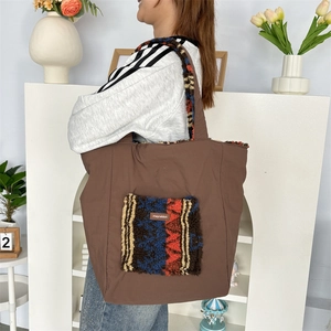 Brown canvas tote bag with colorful plush pocket and lamb wool lined shoulder strap