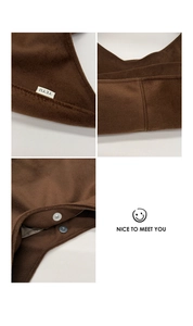 Macro detail of brown wool tote bag featuring YEYU woven label and silver magnetic clasp