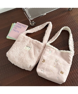 Detail showing two styles of pink plush tote bags with teddy fleece and cute embroidery