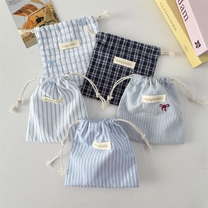 Detailed collection of five cotton drawstring bags in blue stripes and checkered patterns