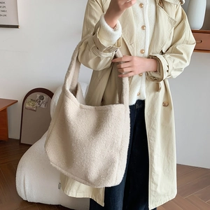 Close-up of the beige plush fleece texture on a large capacity tote shoulder bag