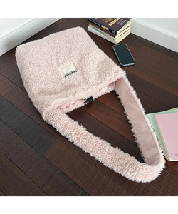 Close-up of pink fuzzy fleece tote bag with SEEYOU label and wide shoulder strap