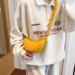 Adjustable yellow crescent crossbody bag shown on model for casual styling and fit