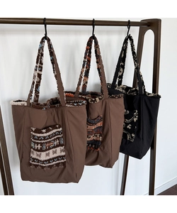 Detailed view of winter tote bags featuring plush jacquard pockets in three colors