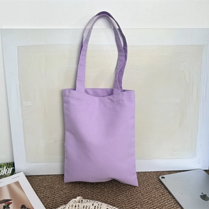 Detailed view of heavy canvas fabric texture on a plain purple shoulder tote bag