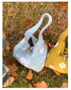 Detail showing the soft plush texture and flower embroidery of the autumn tote bag