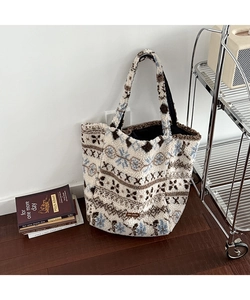 Detail of plush fleece tote bag featuring Nordic jacquard pattern and logo leather patch