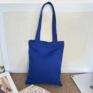 Close-up of royal blue canvas tote bag showing durable texture and minimalist design