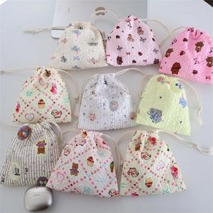 Cartoon drawstring storage pouches in waffle fabric with assorted floral and bear patterns