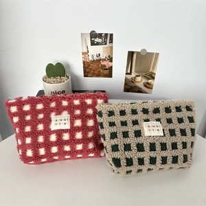 Plush checkered makeup bags in red and green soft fleece with zipper closure