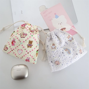 Detail of embossed bubble fabric drawstring bags with cute floral and animal prints