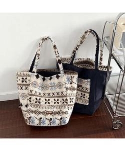 Close-up of plush tote bags featuring jacquard patterns and stitched leather logo tags