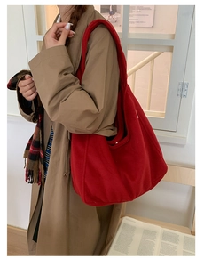 Red wool felt tote bag shown as a stylish shoulder bag with minimalist winter outfit