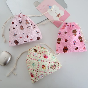 Detailed view of three cartoon drawstring storage bags with cute animal floral patterns