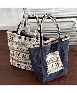 Detail view of large plush tote bags with geometric patterns and fleece textures