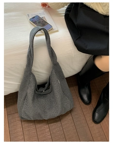 Detailed texture of a large grey felt tote bag shown in a cozy lifestyle setting