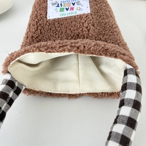 Detail of plush sherpa water bottle sleeve with gingham handle and soft inner lining