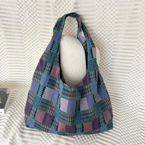 Detail of the colorful plaid tote bag with patchwork cotton fabric and wide shoulder strap
