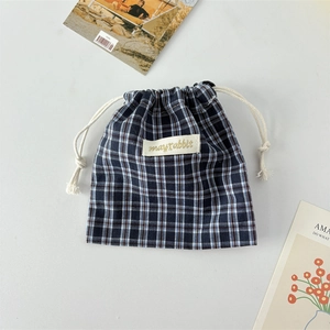 Detailed view of navy blue gingham cotton drawstring bag with mayrabbit logo patch