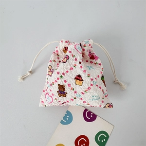 Detailed view of seersucker drawstring bag with cute cartoon bear and rabbit prints
