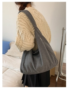 Close-up of a large dark grey wool tote bag showing texture and oversized interior