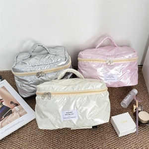 Quilted cosmetic bags with bow texture in silver, pink, and white waterproof fabric