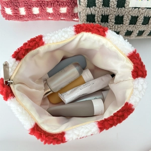 Detail view of large capacity plush checkerboard makeup bag with spacious interior storage