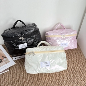 Waterproof PU leather cosmetic bags with quilted bow pattern in black, pink, and ivory