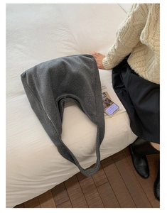Detailed view of the soft wool texture and minimalist hobo shape of the grey tote bag