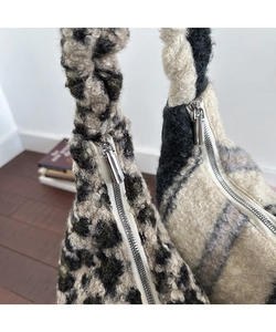 Dettaglio delle borse tote in ecopelliccia leopardata e a scacchi con cerniere in metallo