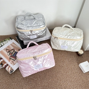 Waterproof PU leather cosmetic bags with quilted bow pattern in silver, pink, and white