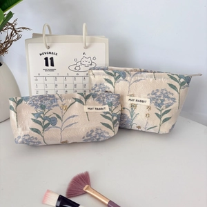 Floral jacquard cosmetic bag set with beige canvas and blue flower pattern for travel