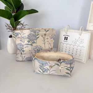 Detail of floral embroidery on jacquard makeup bags with premium metallic zippers