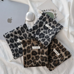 Set of four plush leopard print drawstring pouches with cotton ties and brand labels