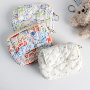 Detailed view of quilted mini organizers with floral patterns and metal zipper hooks