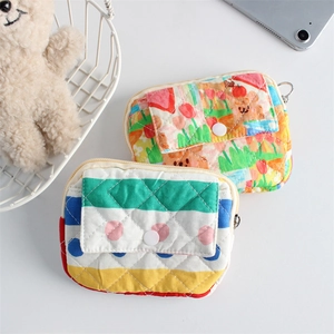 Detailed view of floral and striped quilted mini pouches for coins and accessories