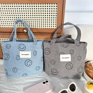 Corduroy lunch bags with cute smiley faces in blue and grey, versatile tote bags