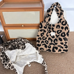 Detailed view of plush leopard print tote bags with soft faux fur and magnetic snap closure