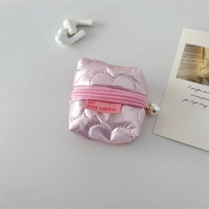 Close-up of pink heart-quilted earphone pouch with pearl zipper and brand label