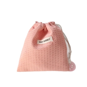Pink waffle texture drawstring pouch for makeup with May Rabbit woven label