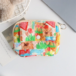 Close-up of cute floral quilted storage pouch with cartoon bear prints and metal zipper