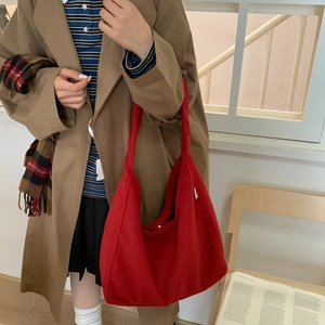 Minimalist red woolen shoulder tote bag for women shown in a stylish lifestyle setting