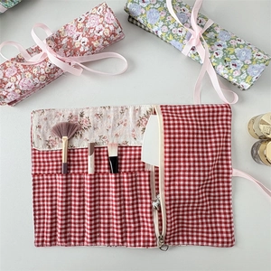 Floral fabric makeup brush roll-up bag with ribbon tie and multi-slot storage