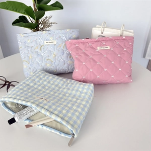 Quilted cotton makeup bags with zippers shown in light blue, pink, and checkered patterns