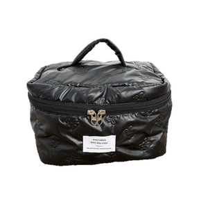 Black quilted makeup bag with bow pattern texture and convenient carrying handle