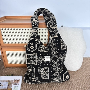 Close-up of geometric plush tote bag on a rattan cabinet in a cozy home setting