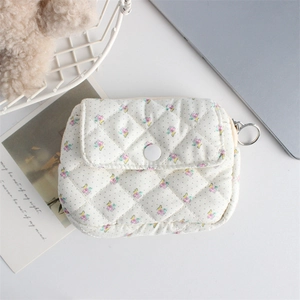 Close-up of floral quilted organizer bag with flip cover and metal hanging hook detail