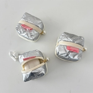 Detail view of silver quilted PU earphone case with pearl zipper and red brand label
