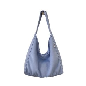Light blue fuzzy woolen tote bag with a spacious minimalist design and wide shoulder strap