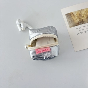 Macro detail of silver PU earphone pouch with pearl zipper and pink label insert